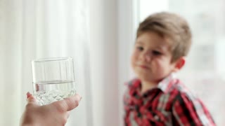 videoblocks-mom-bringing-her-thirsty-son-glass-of-water-little-boy-drinking-water-from-glass-maternal-care-thirsty-child-closeup-portrait-clear-glass-with-cold-pure-water-mother-taking-care-of-her-small-kid_hmdzvih2e_thumbnail-small01.jpg