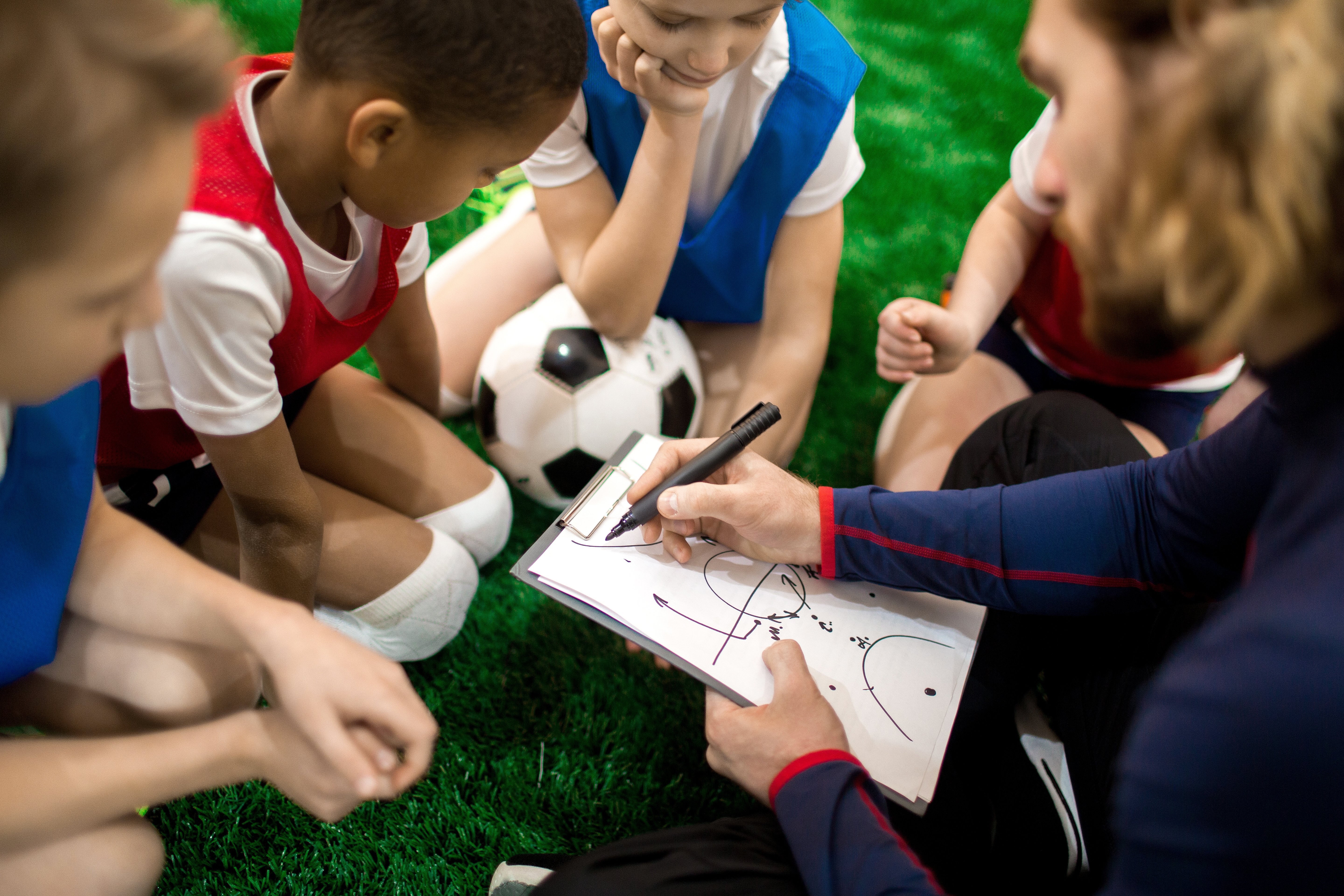 coach of youth sports organization with clipboard