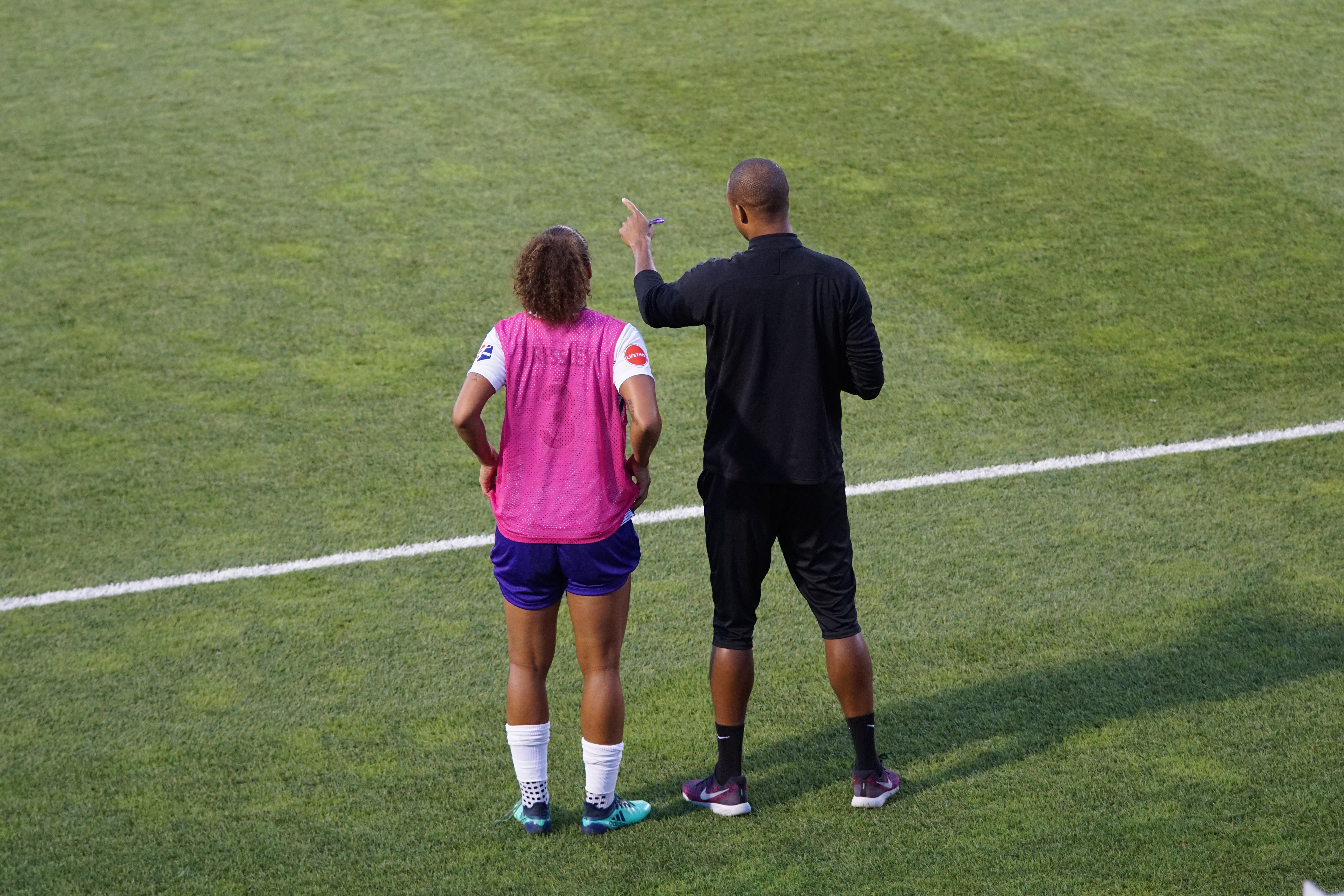 Coach on the field with athlete