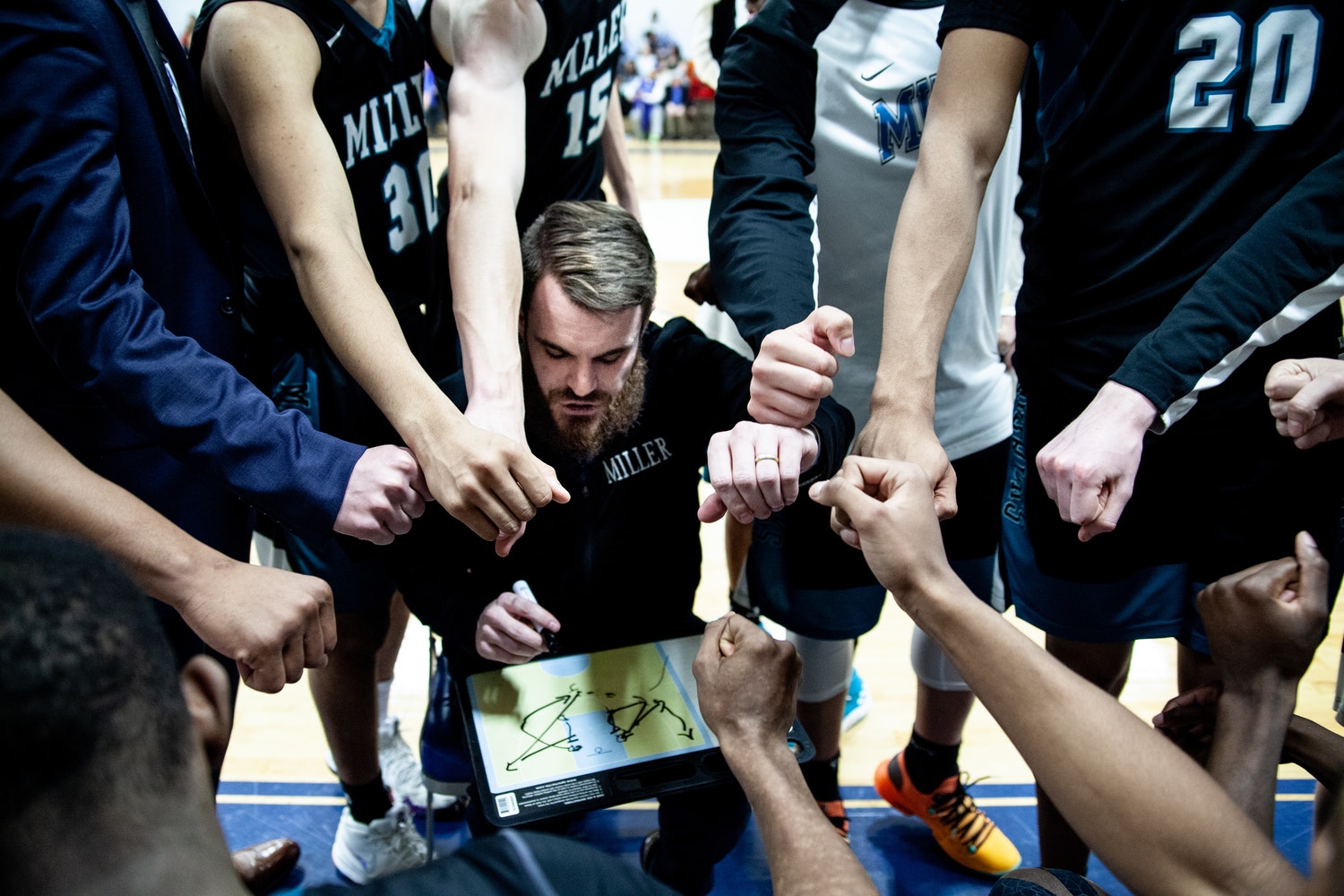 Coach and Players in a Huddle